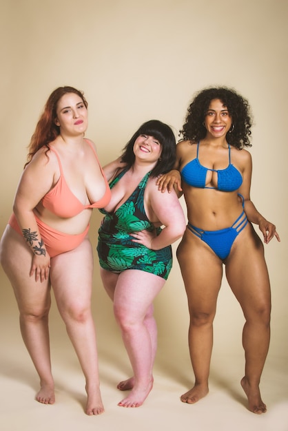 Group of 3 oversize women posing in studio