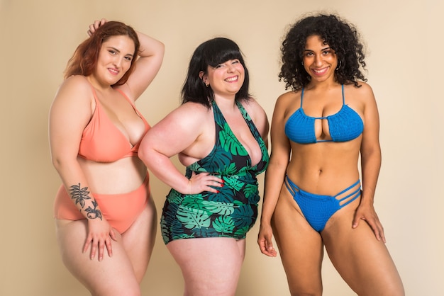 Group of 3 oversize women posing in studio