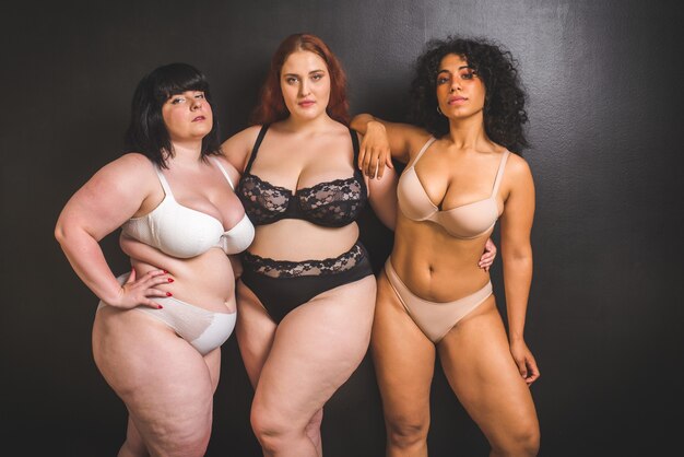 Group of 3 oversize women posing in studio