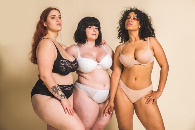 Group of 3 oversize women posing in studio