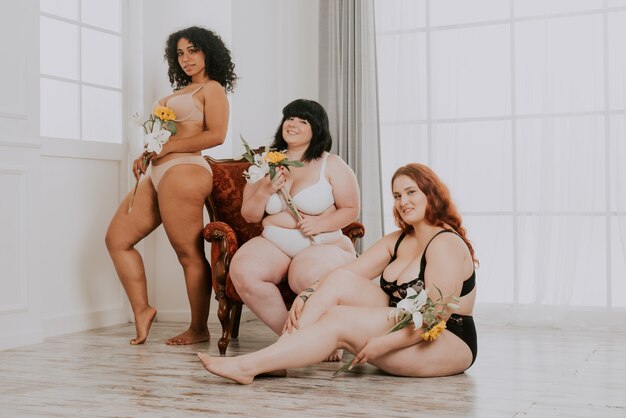 Group of 3 oversize women posing in studio