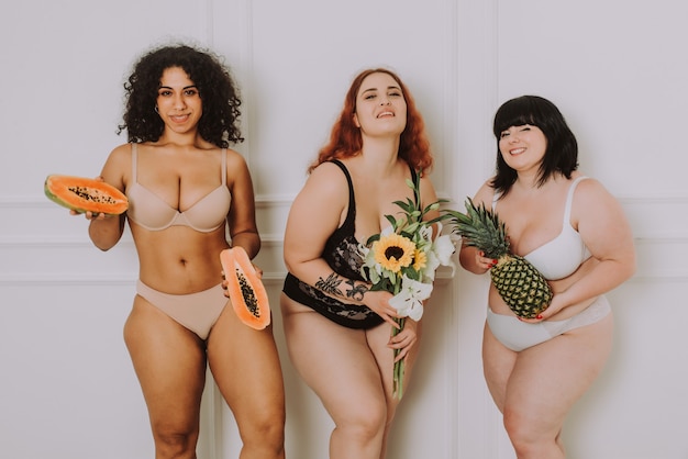 Group of 3 oversize women posing in studio