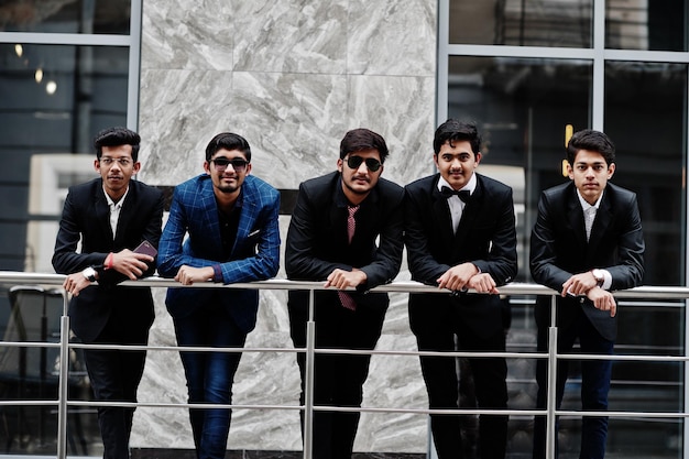 Group of 5 indian students in suits posed outdoor