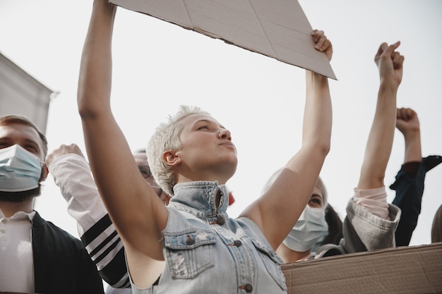 Photo group of activists giving slogans in a rally men and women marching together in a protest in the