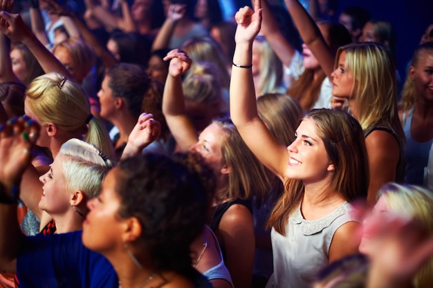 A group of adoring fans singing along to their favorite song The best live performance concert