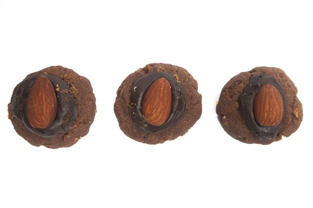 Group of afghan cookies made from chocolate and cornflakes with almond on top view isolated on white background clipping path