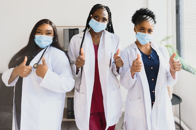 Group of african american female doctors in protective masks on their faces