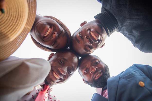 Group of african friends do head to head and smile together happiness and friendship concept photo from below