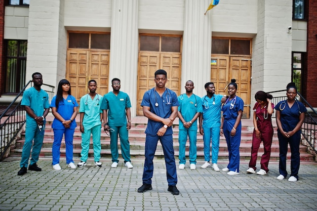 Group of african medical students posed outdoor against university door