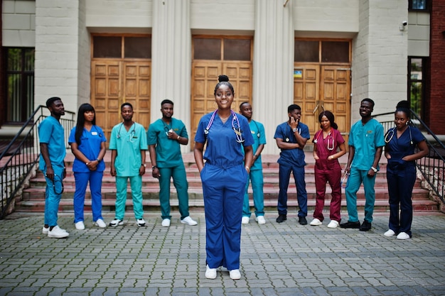 Group of african medical students posed outdoor against university door