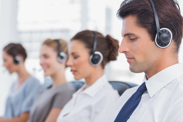 Group of agents sitting in line in a bright call centre