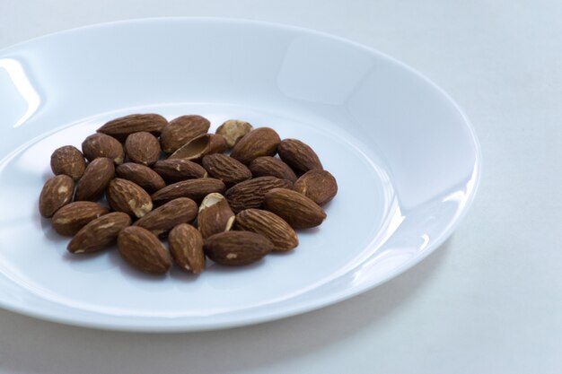 Group Almond on white dish close front side view