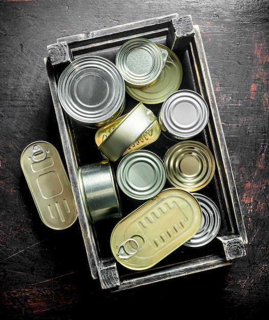 Group of aluminum closed cans with canned food in a box