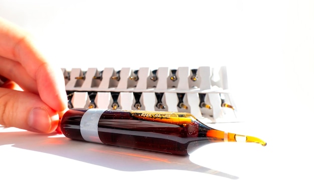 Group of ampoules with a transparent medicine in medical laboratory lot of ampoules on light background