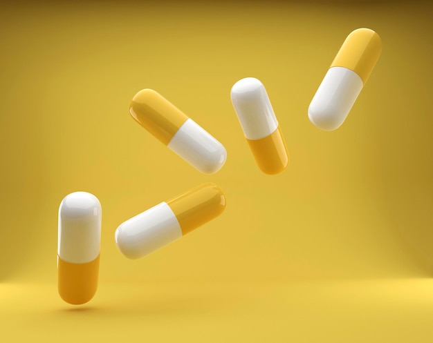 group of antibiotic capsules falls on the yellow background Health care and medicine