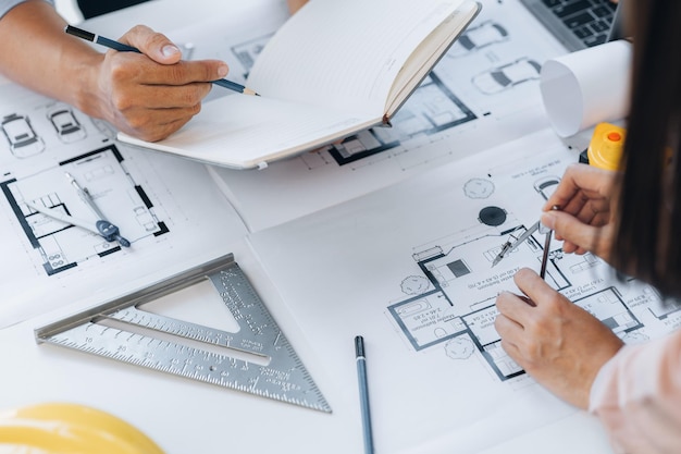 A group of architects designing buildings and houses is having\
a meeting with the project owners about the house designs in the\
housing project home and interior design ideas by architect\
engineers
