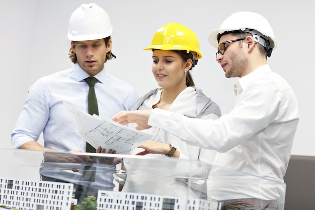 Group of architects sharing ideas in modern office