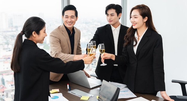 Group of Asian business people holding glasses of wine to celebrate new year