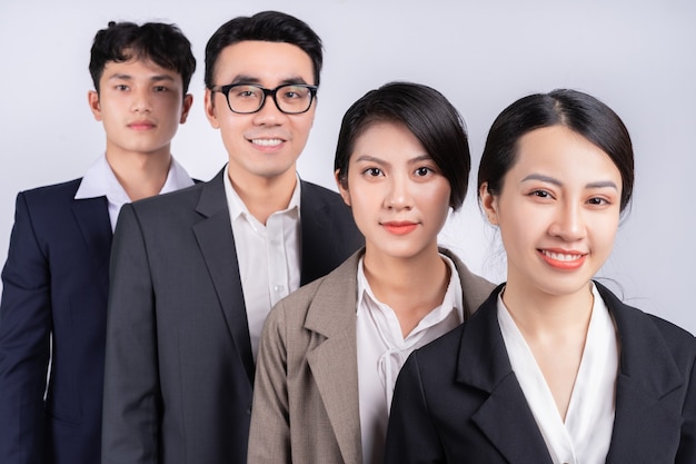 Group of Asian business people posing on a white background