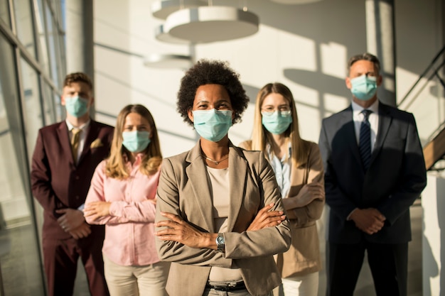 Photo group of asian business people standing in office and wear mask for protect prevent infection by corona virus