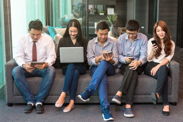 Group Of Asian Business people with casual suit using mobile