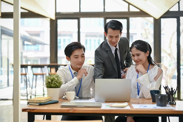 A group of Asian businesspeople are brainstorming and planning an investment project