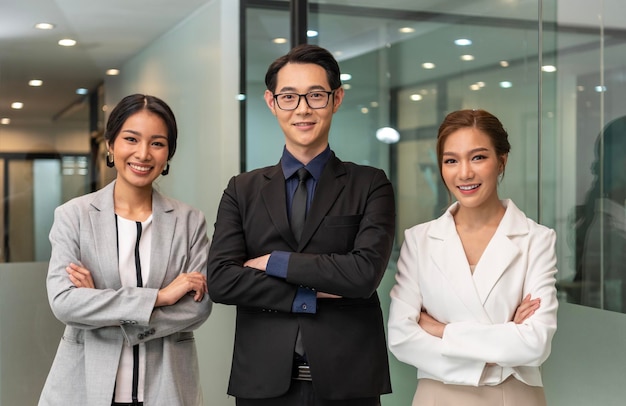 Group of asian businesspeople with arms crossed in office