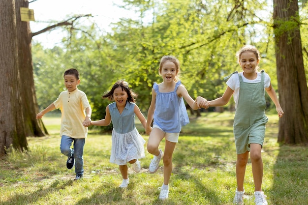 Gruppo di bambini asiatici e caucasici che si divertono nel parco