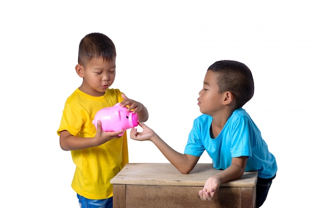 Group of asian children have fun with piggy bank isolated on white 