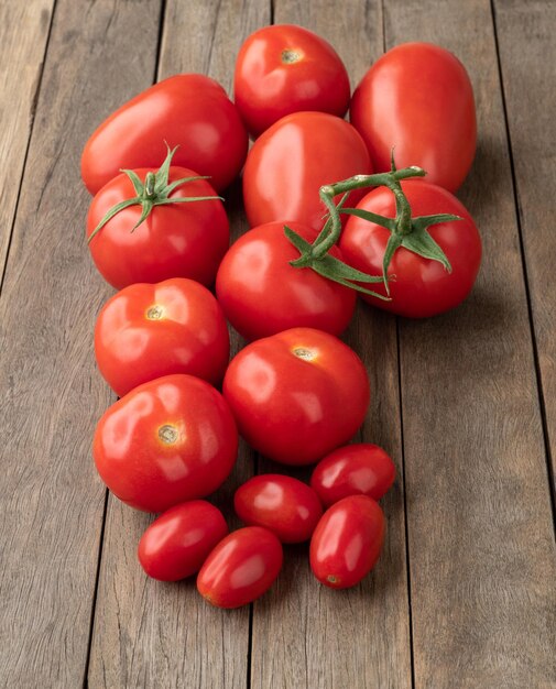 A group of assorted tomatoes over wooden table