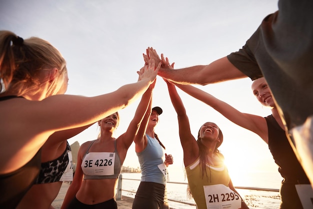 Photo group of athletes high fiving after race