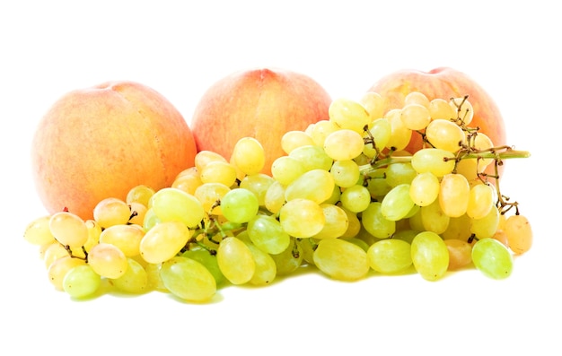 Group of autumn fruits (grapes, peaches ) isolated on white background