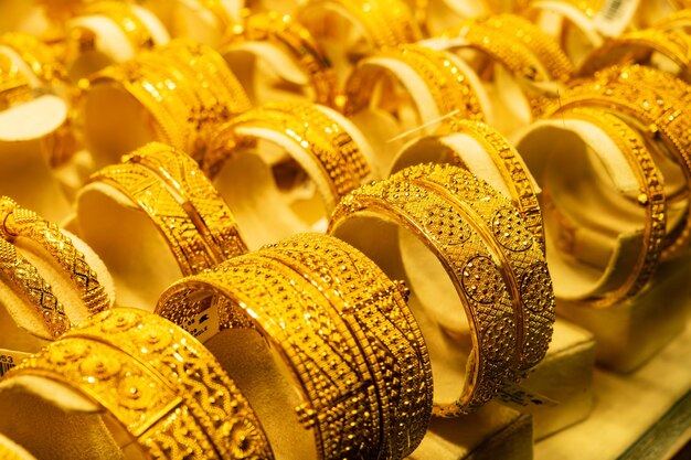 Group of beautiful elegant gold jewelry bracelet expensive accessory Luxurious gold bracelets on the background