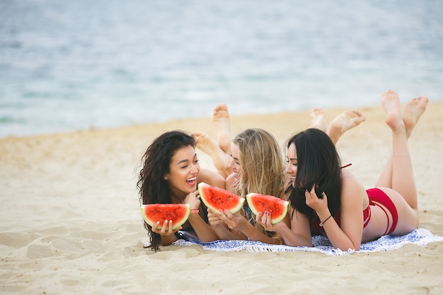 A group of beautiful young girls on the beach tanning