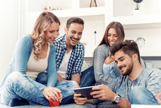 Group of beautiful young people enjoying at home