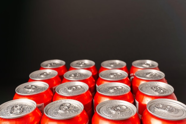 group of beer cans with water drops with black background