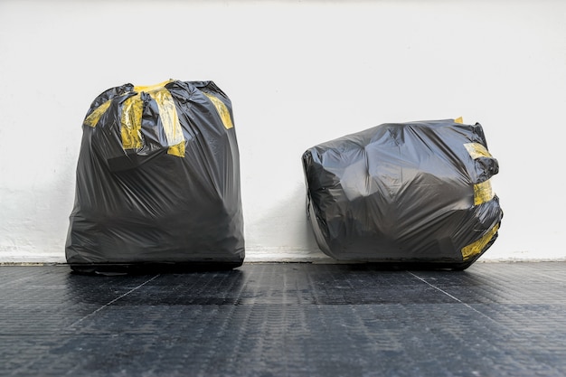 Photo group of black garbage bags put fully covered with adhesive tape .