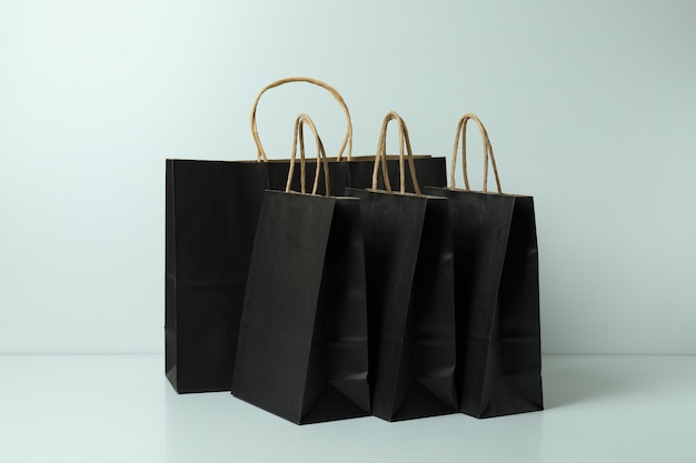 Group of black paper bags on white