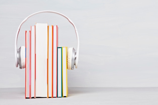 Photo group of books with the earphones. audiobooks concept