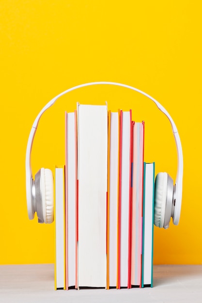 Group of books with the earphones. Audiobooks concept