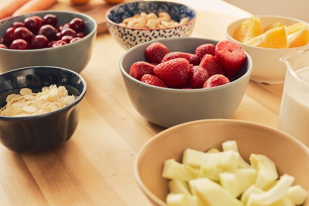 Group of bowls with fresh berries and fruits for smoothie