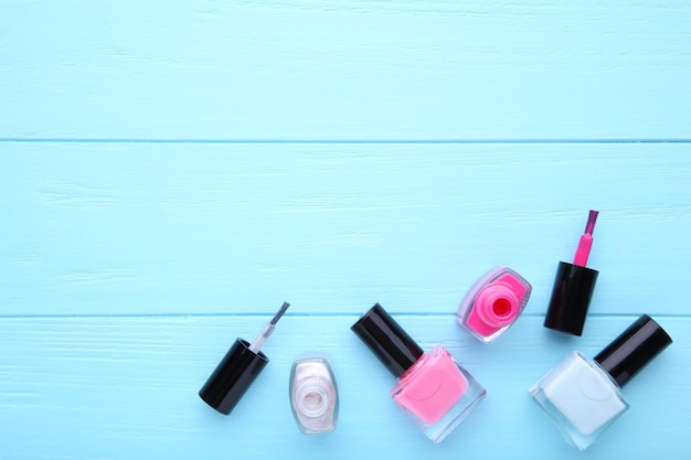 Group of bright nail polishes on blue