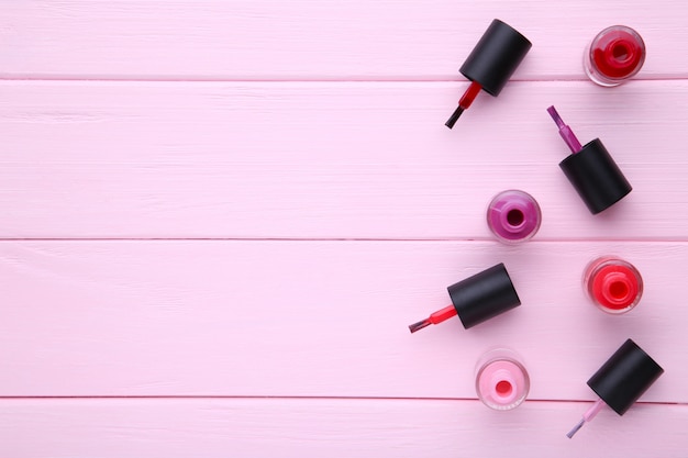 Photo group of bright nail polishes on pink