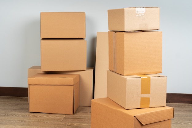 Group of brown carton boxes on wooden floor