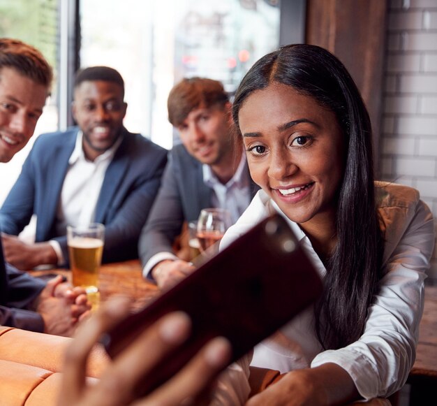 Group Of Business Colleagues Posing For Selfie In Bar After Work