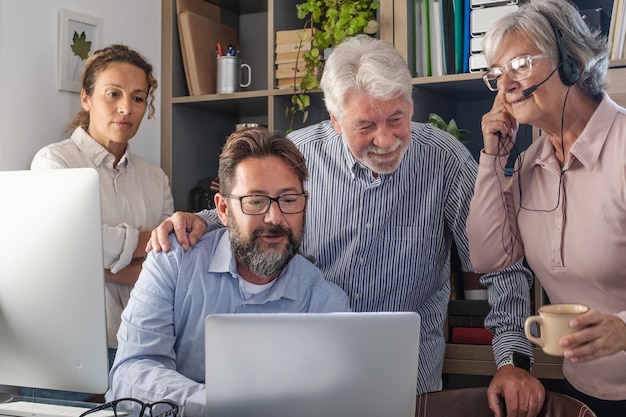 Group of business men and women working and communicating together in creative office - conference in video call