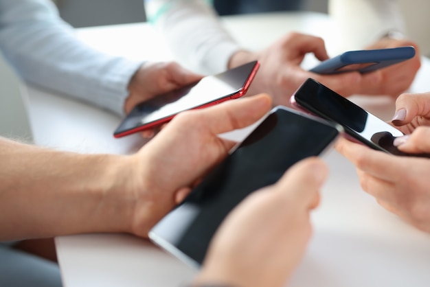 Group of business people are holding mobile phones in office phone addiction nomophobia concept