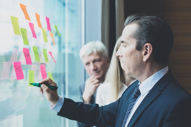 Photo group of business people brainstorming ideas. entrepreneurs having a standing meeting discussing ideas strategy planning problem solution concept