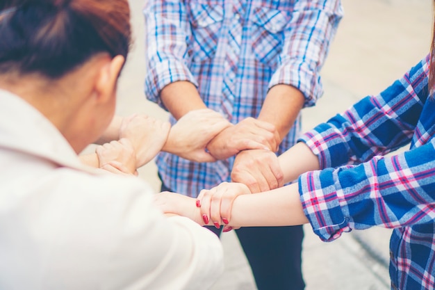 Group of business people crossed arms in pile for win. stack of hands. cooperation concept