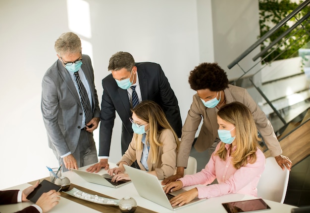 Group business people have a meeting and working in office and wear masks as protection